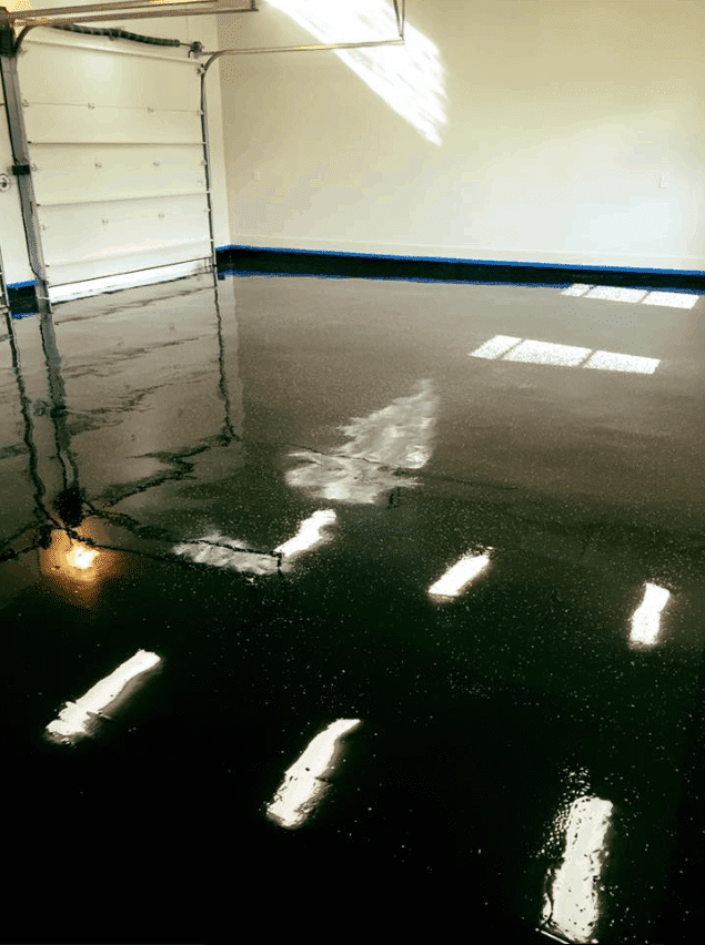 Black shiny epoxy coated floor of a big commercial garage