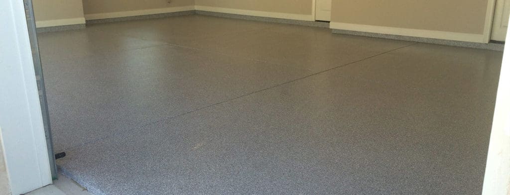 Chip epoxy coated on a square concrete floor of a residential house
