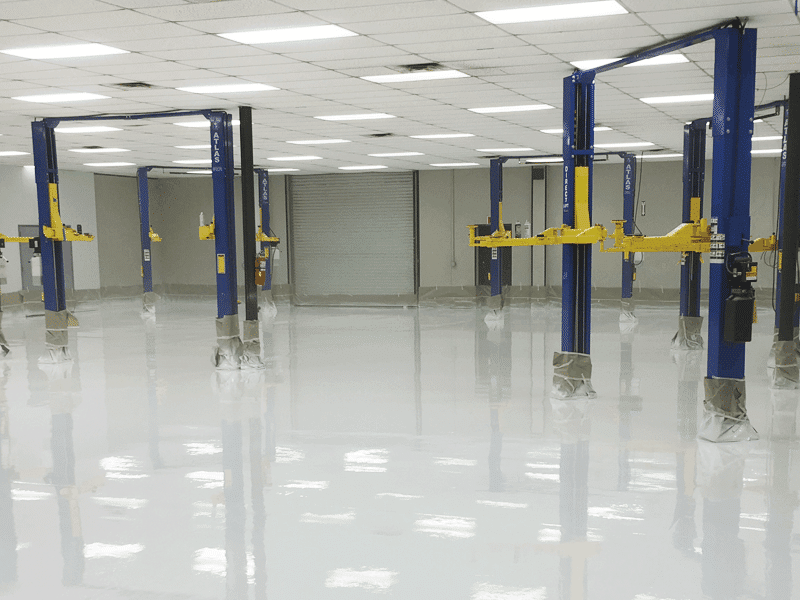 White reflactive epoxy coated on a big industrial car garage floor