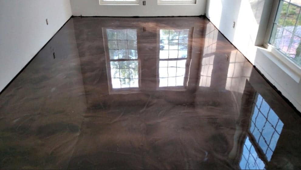 Reflactive metalic epoxy coating installed on a square concrete floor of a residential house