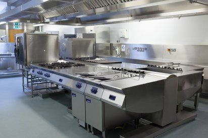 Solid gray epoxy coated floor of a big commercial kitchen