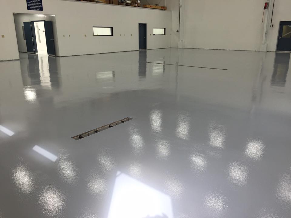 White reflactive epoxy coated floor of a airplane hangar space