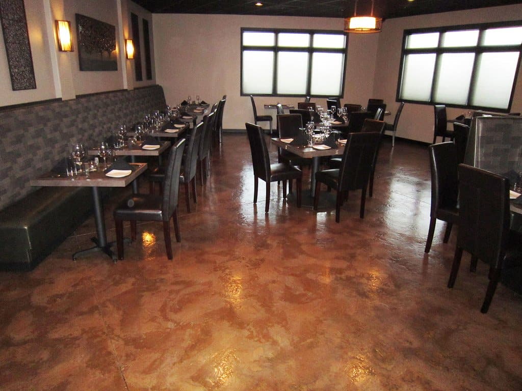 Beautiful red stained epoxy coating floor of a restaurant interior