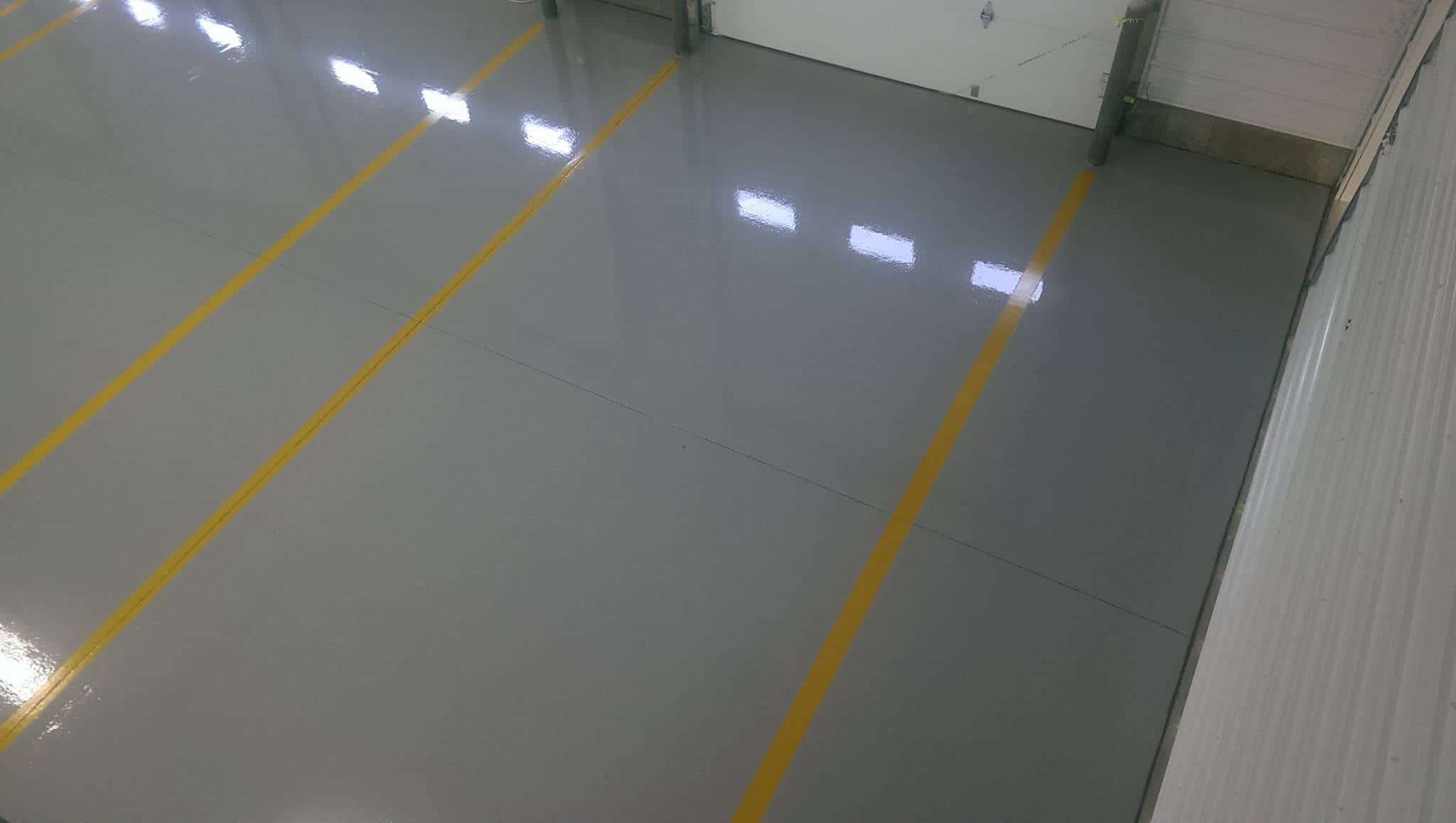 Yellow striped reflactive epoxy coated garage floor of a commercial space