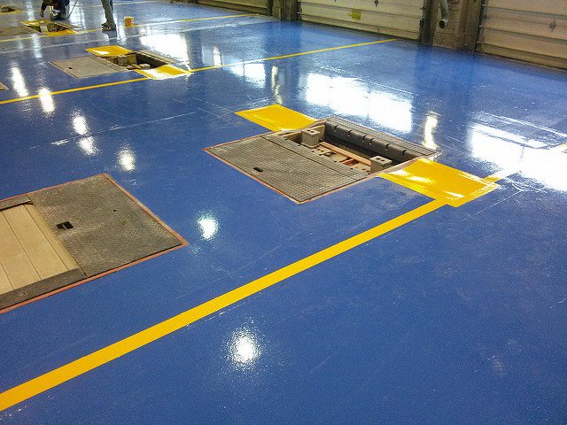 Beautiful yellow epoxy striping installed in a commercial car garage